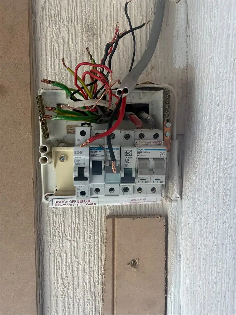 An ageing consumer unit wired in the old red and black colours